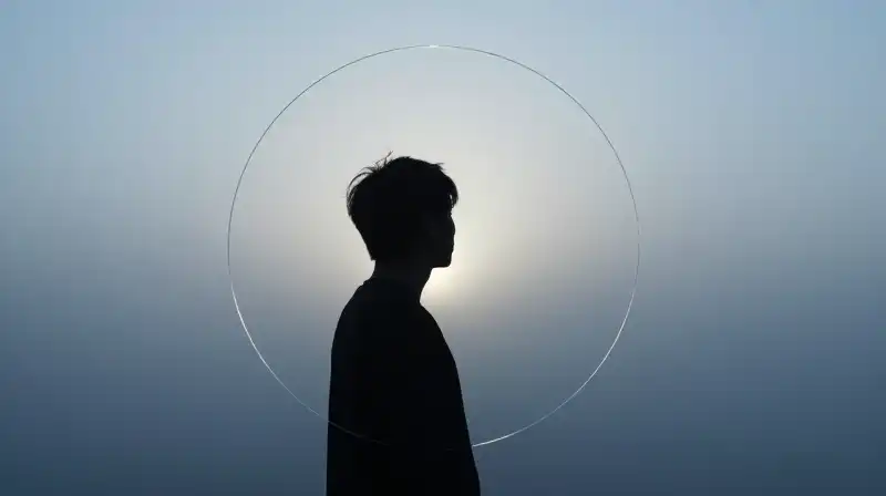 A silhouetted figure turns toward light within protective glass