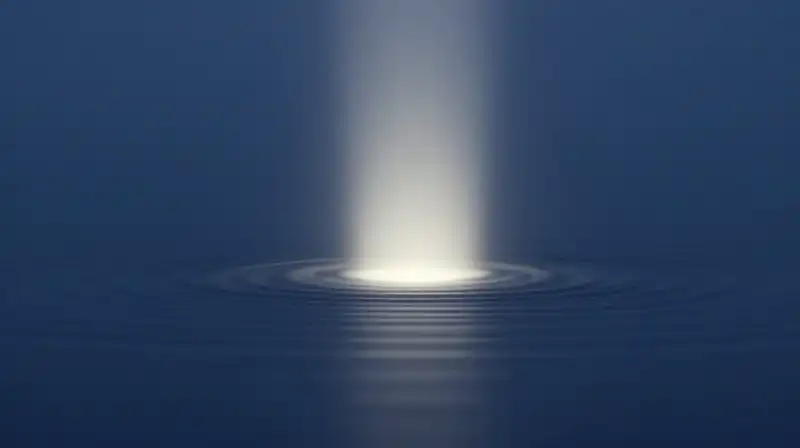 A glowing pillar of light ripples across deep blue