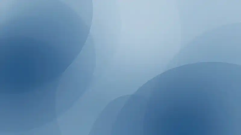 Translucent blue geometric shapes overlap in a soft, ethereal atmosphere
